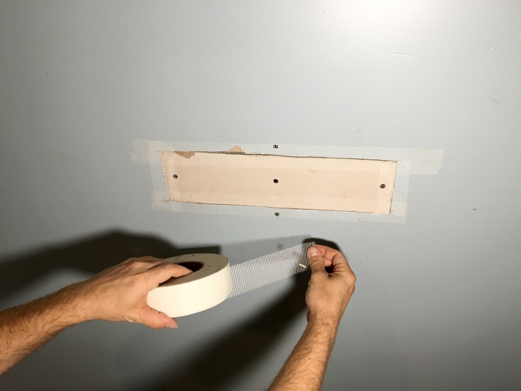 Drywall patch being taped by Just Add Paint 