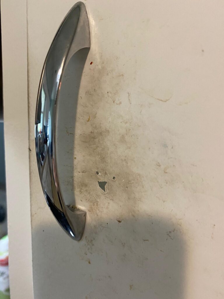 Paint failure around cabinet handle